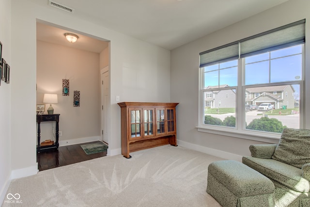 sitting room featuring visible vents, baseboards, and carpet floors