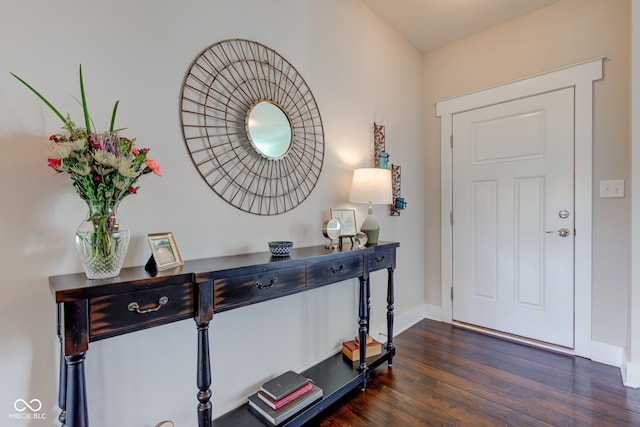 entryway with baseboards and dark wood-type flooring