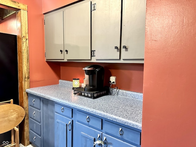 812 W Walnut Dr, Rockville, IN 47872 - kitchen featuring light countertops, white cabinets, and blue cabinetry