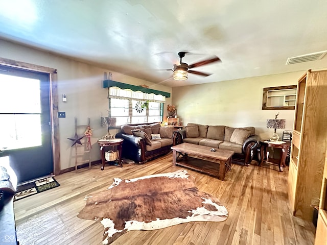 812 W Walnut Dr, Rockville, IN 47872 - living room featuring visible vents, light wood-style flooring, ceiling fan, and a healthy amount of sunlight