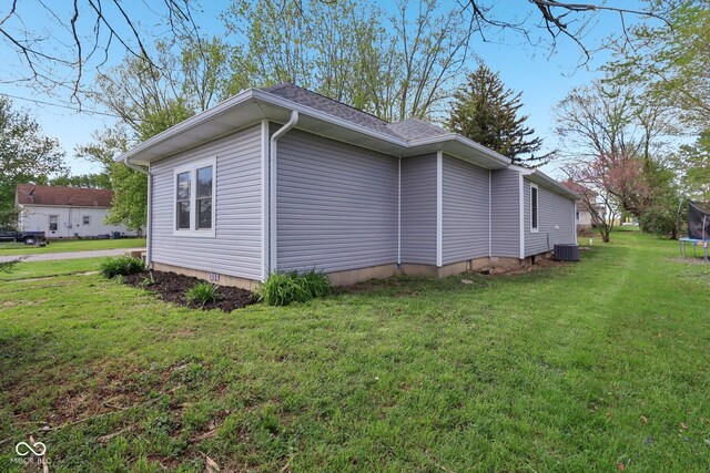 3098 Central, Arlington, IN 46104 - view of side of home featuring a trampoline, a yard, and cooling unit