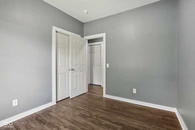 3098 Central, Arlington, IN 46104 - unfurnished bedroom with baseboards, dark wood-style floors, and a closet