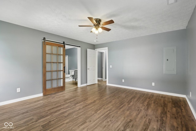 3098 Central, Arlington, IN 46104 - interior space with ceiling fan, electric panel, a barn door, wood finished floors, and baseboards