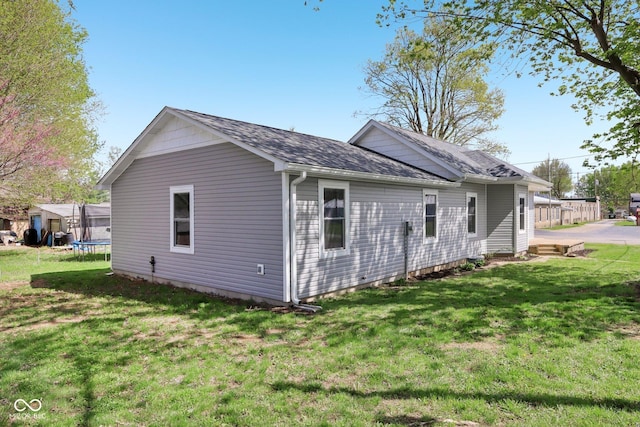 3098 Central, Arlington, IN 46104 - view of home's exterior featuring a lawn, roof with shingles, and a trampoline
