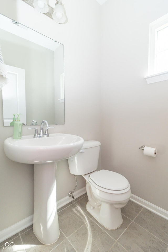 192 Lynnette Way, Cumberland, IN 46229 - bathroom featuring toilet, tile patterned floors, a sink, and baseboards