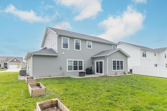 192 Lynnette Way, Cumberland, IN 46229 - rear view of house featuring a garden, central AC, fence, a patio, and a lawn