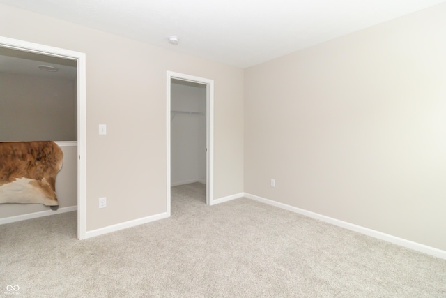 192 Lynnette Way, Cumberland, IN 46229 - unfurnished bedroom with baseboards, light colored carpet, a spacious closet, and a closet