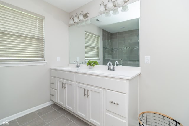 192 Lynnette Way, Cumberland, IN 46229 - bathroom with double vanity, tile patterned floors, tiled shower, and a sink