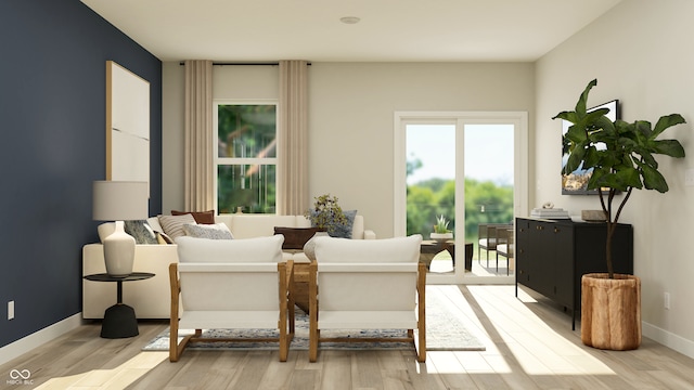 sitting room with baseboards and light wood-style floors