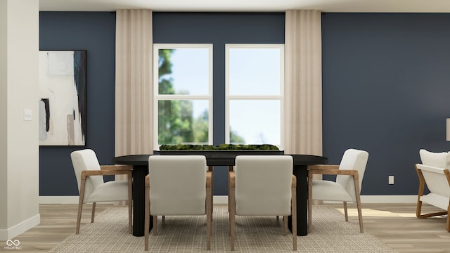 dining space featuring baseboards and wood finished floors
