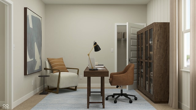 carpeted office space featuring baseboards