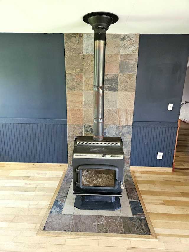 1647 State Ferry Rd, Solsberry, IN 47459 - room details with wainscoting, wood finished floors, and a wood stove