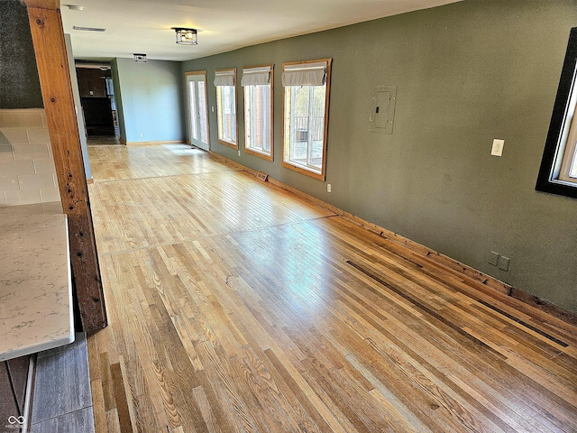 1647 State Ferry Rd, Solsberry, IN 47459 - unfurnished room with baseboards, visible vents, light wood finished floors, and electric panel