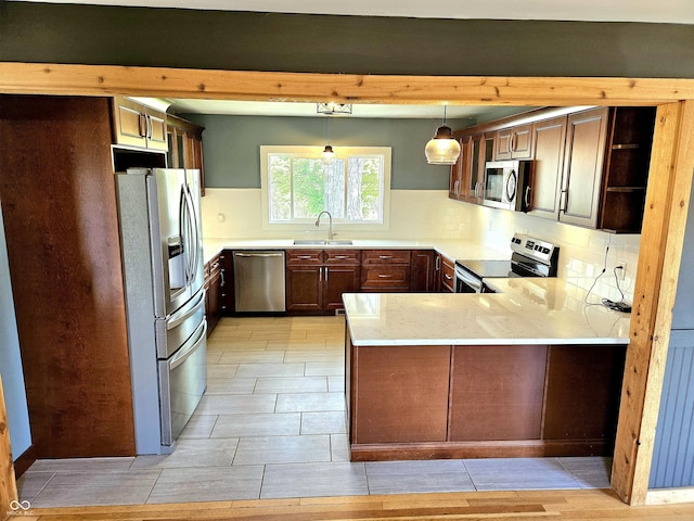 1647 State Ferry Rd, Solsberry, IN 47459 - kitchen with open shelves, a peninsula, light countertops, a sink, and appliances with stainless steel finishes