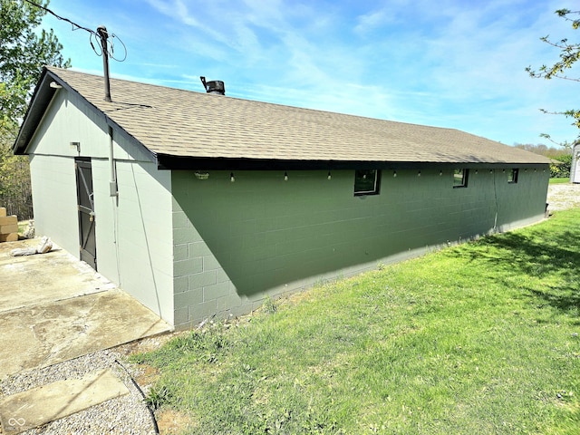1647 State Ferry Rd, Solsberry, IN 47459 - view of property exterior featuring a yard, a shingled roof, an outdoor structure, and concrete block siding