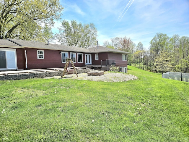 1647 State Ferry Rd, Solsberry, IN 47459 - back of property with a lawn, fence, and an outdoor fire pit