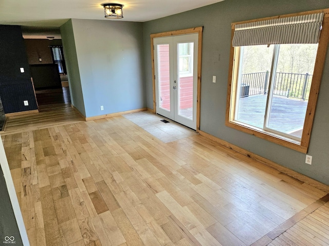 1647 State Ferry Rd, Solsberry, IN 47459 - spare room featuring baseboards, french doors, and light wood-style flooring