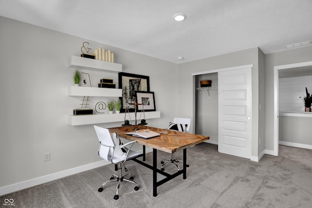 carpeted office featuring baseboards