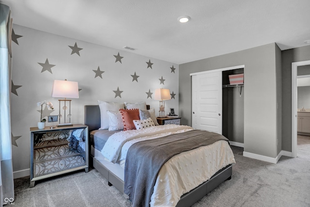 carpeted bedroom with baseboards, visible vents, and a closet