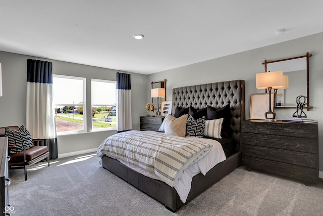 bedroom featuring baseboards and carpet