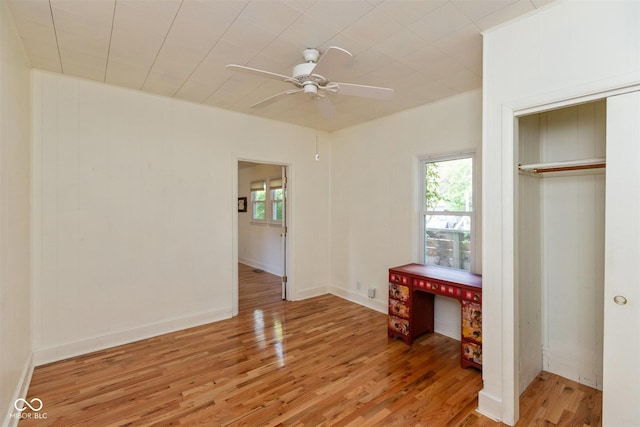4710 Hinesley Ave, Indianapolis, IN 46208 - unfurnished bedroom featuring a closet, ceiling fan, multiple windows, and light wood-type flooring
