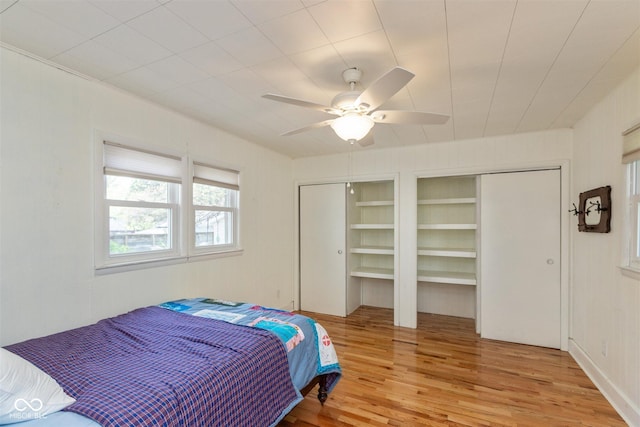 4710 Hinesley Ave, Indianapolis, IN 46208 - bedroom featuring light wood-style floors, a ceiling fan, and two closets