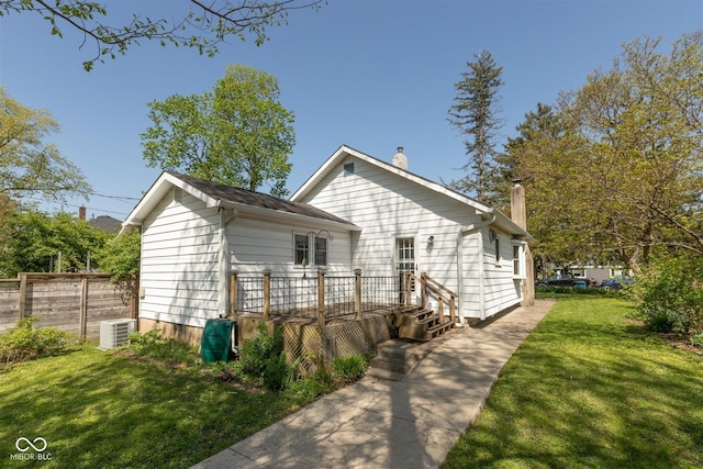 4710 Hinesley Ave, Indianapolis, IN 46208 - view of front of property with a chimney, a deck, central air condition unit, fence, and a front lawn