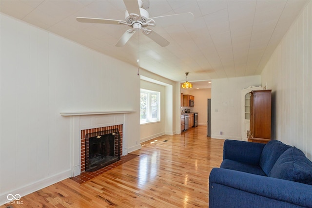 4710 Hinesley Ave, Indianapolis, IN 46208 - living area featuring light wood-style floors, ceiling fan, and a fireplace