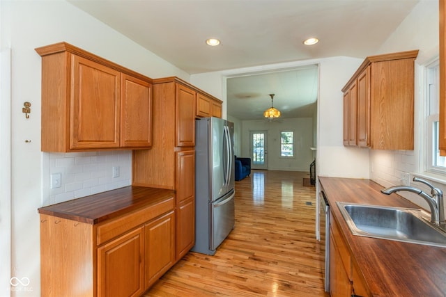 4710 Hinesley Ave, Indianapolis, IN 46208 - kitchen with decorative backsplash, light wood-type flooring, a sink, wood counters, and stainless steel appliances