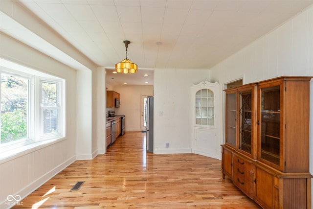 4710 Hinesley Ave, Indianapolis, IN 46208 - unfurnished dining area featuring visible vents and light wood-style flooring