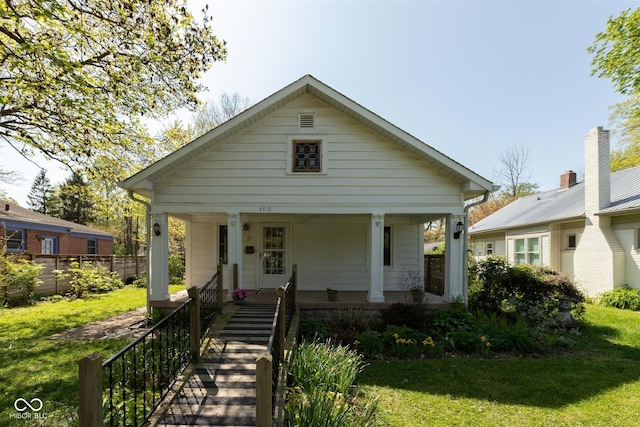 4710 Hinesley Ave, Indianapolis, IN 46208 - bungalow-style home with covered porch and a front yard