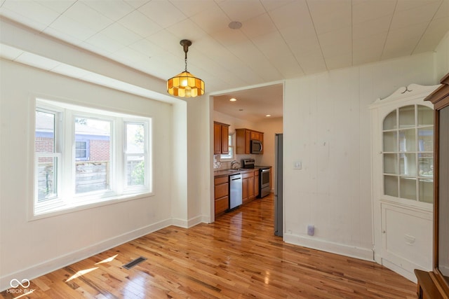 4710 Hinesley Ave, Indianapolis, IN 46208 - unfurnished dining area with baseboards, light wood-type flooring, and visible vents