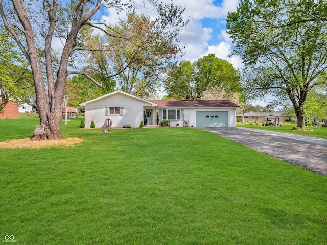 single story home with an attached garage, driveway, and a front yard