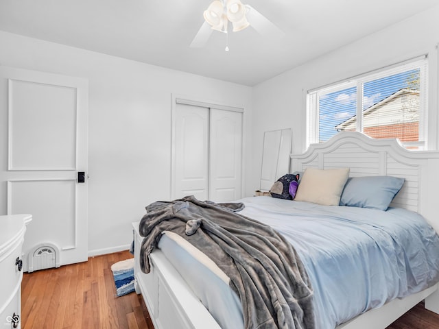 bedroom featuring a closet, radiator, ceiling fan, and wood finished floors