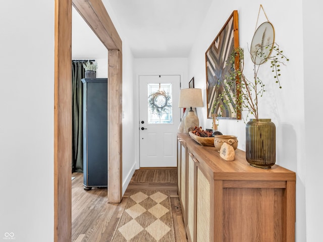 entryway featuring baseboards and light wood-style flooring