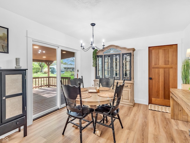dining area featuring an inviting chandelier and light wood-style flooring