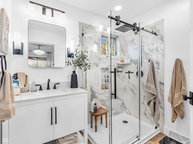 full bathroom with vanity and a marble finish shower
