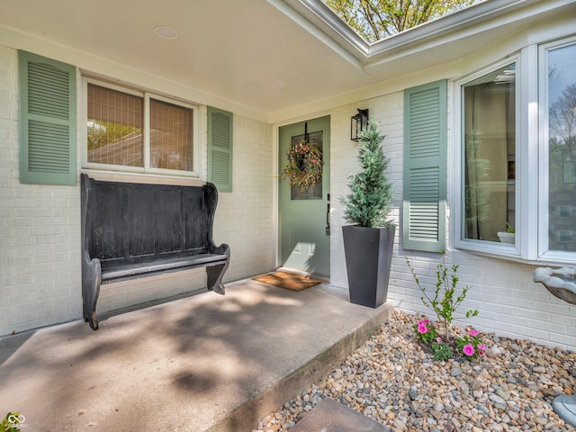 entrance to property featuring brick siding
