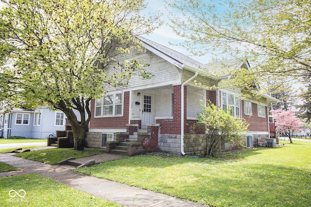 bungalow-style home with central AC and a front yard