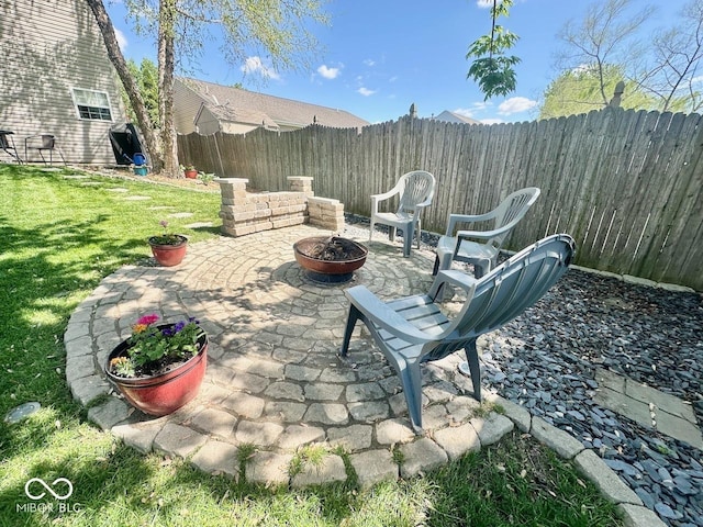 view of patio with a fire pit and a fenced backyard