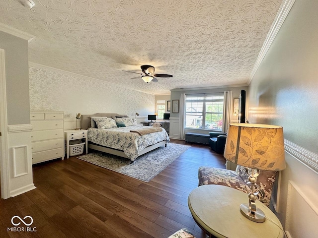 bedroom featuring crown molding, a textured ceiling, ceiling fan, and hardwood / wood-style flooring