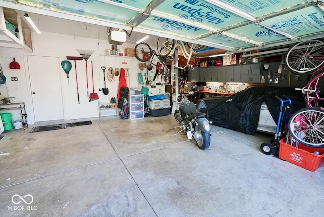 garage with a workshop area and a garage door opener