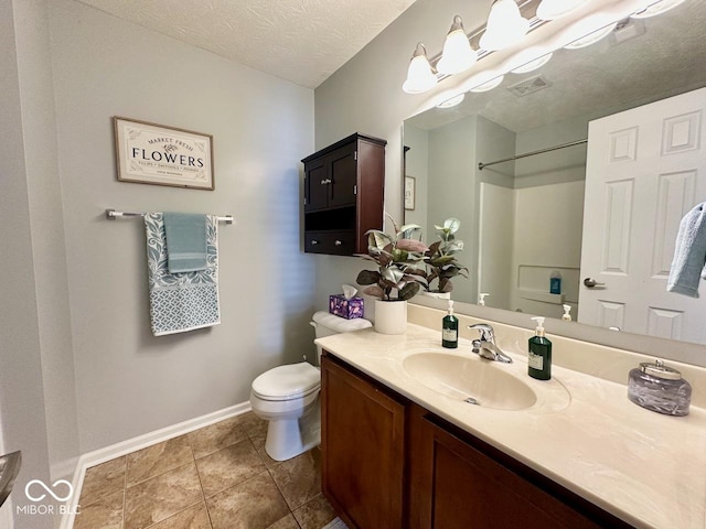 full bathroom featuring vanity, toilet, a textured ceiling, baseboards, and visible vents