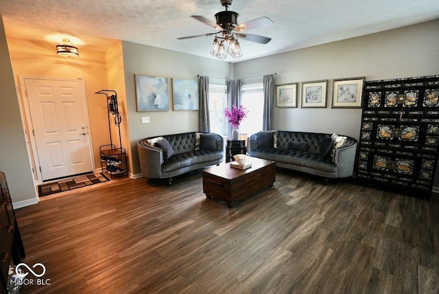 living room featuring a textured ceiling, ceiling fan, and wood finished floors