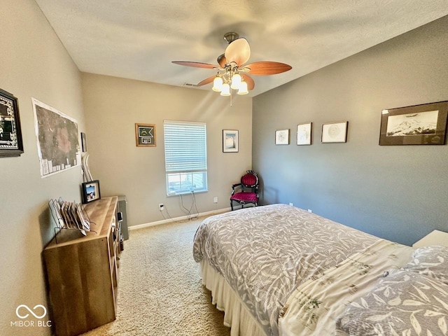 carpeted bedroom with baseboards and a ceiling fan