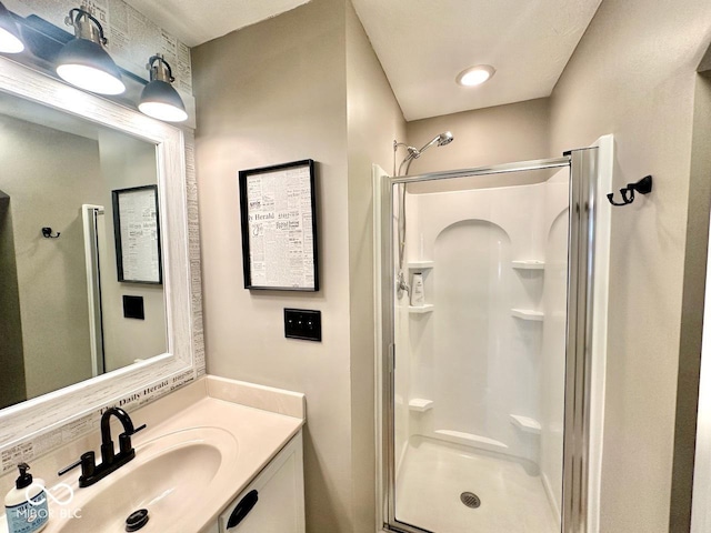 bathroom featuring vanity and a shower stall