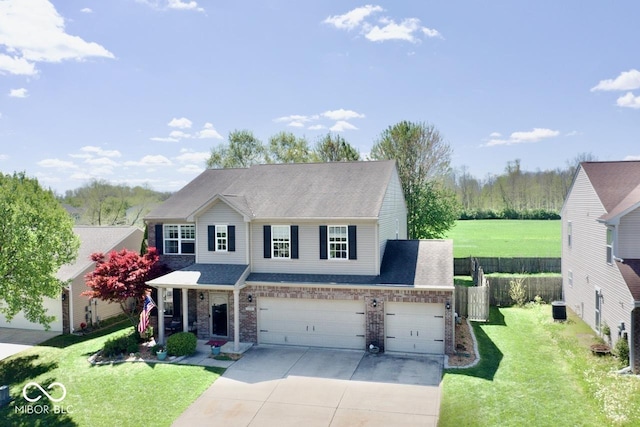 view of front of home featuring a front lawn, roof with shingles, fence, and concrete driveway