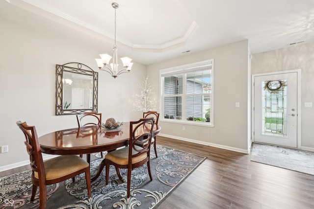 9359 Foudray Cir N, Avon, IN 46123 - dining space featuring wood finished floors, a raised ceiling, a chandelier, baseboards, and ornamental molding