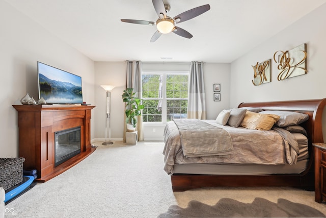 9359 Foudray Cir N, Avon, IN 46123 - bedroom featuring carpet floors, a glass covered fireplace, ceiling fan, and baseboards
