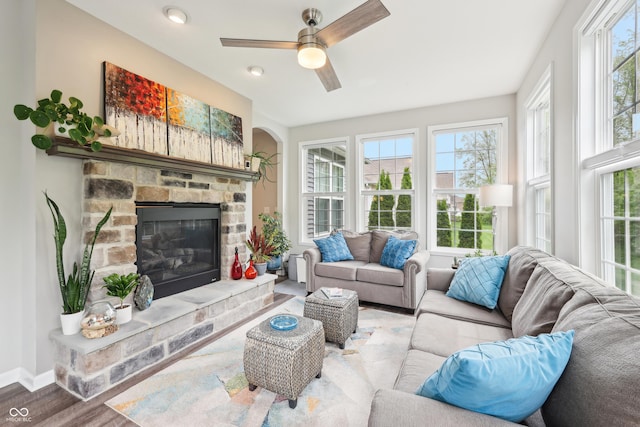 9359 Foudray Cir N, Avon, IN 46123 - living area with wood finished floors, a fireplace, a ceiling fan, and baseboards